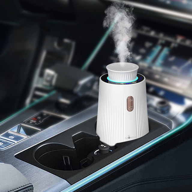 Car diffuser placed in an automobile interior, emitting steam and surrounded by the car's console, illustrating the product in use.