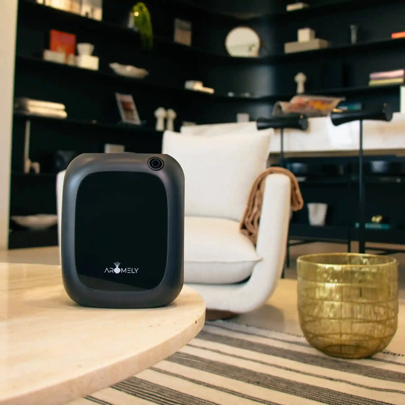 Aromely ARO 25 MAX black scent diffuser with cold air tech covers 1,500 sq ft, Bluetooth enabled on edge of table