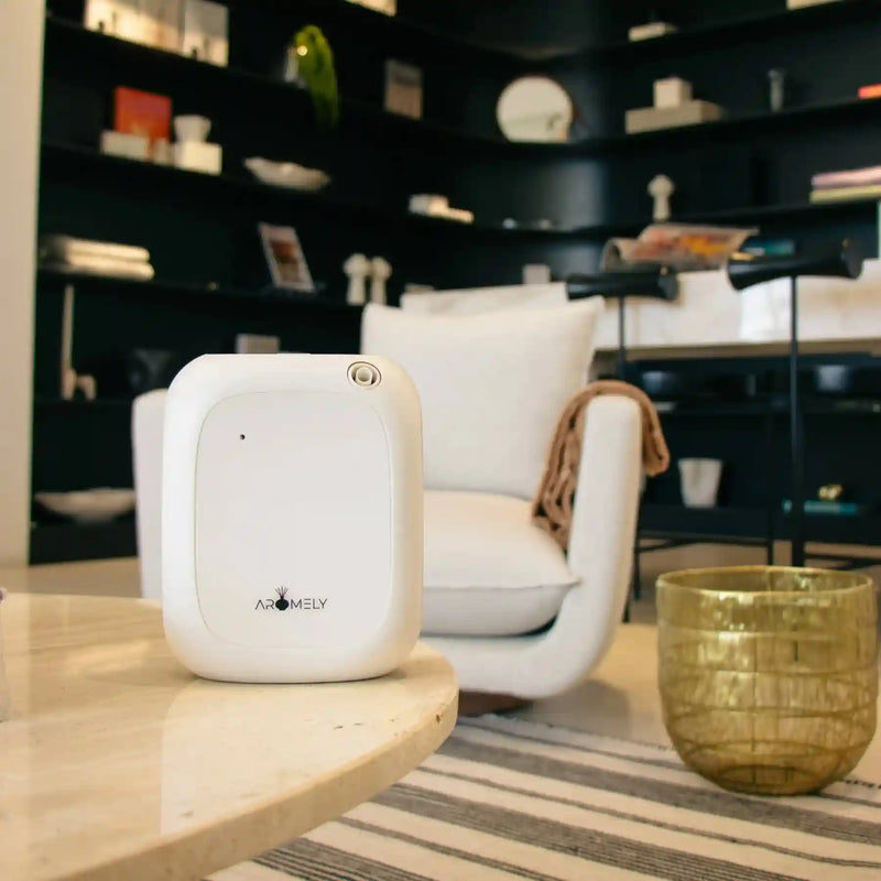 Aromely ARO 25 MAX white scent diffuser with cold air tech covers 1,500 sq ft, Bluetooth enabled on the edge of table