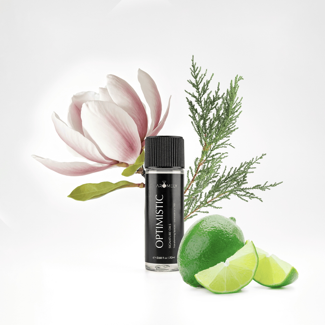 Aromely Optimistic essential oil blend, 20ml bottle, with fresh limes, magnolia flowers, and cypress leaves. A bright, uplifting citrus scent that transforms any room into an invigorating resort-like escape.