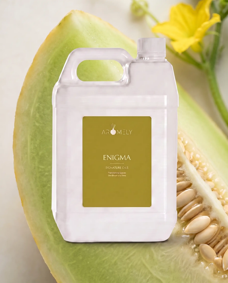 Aromely Enigma fragrance oil bottle, 1 Gallon, against green melon