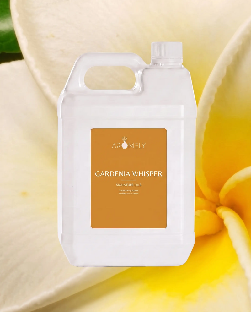 Aromely Gardenia Whisper fragrance oil bottle, 1 Gallon, against white and yellow petals