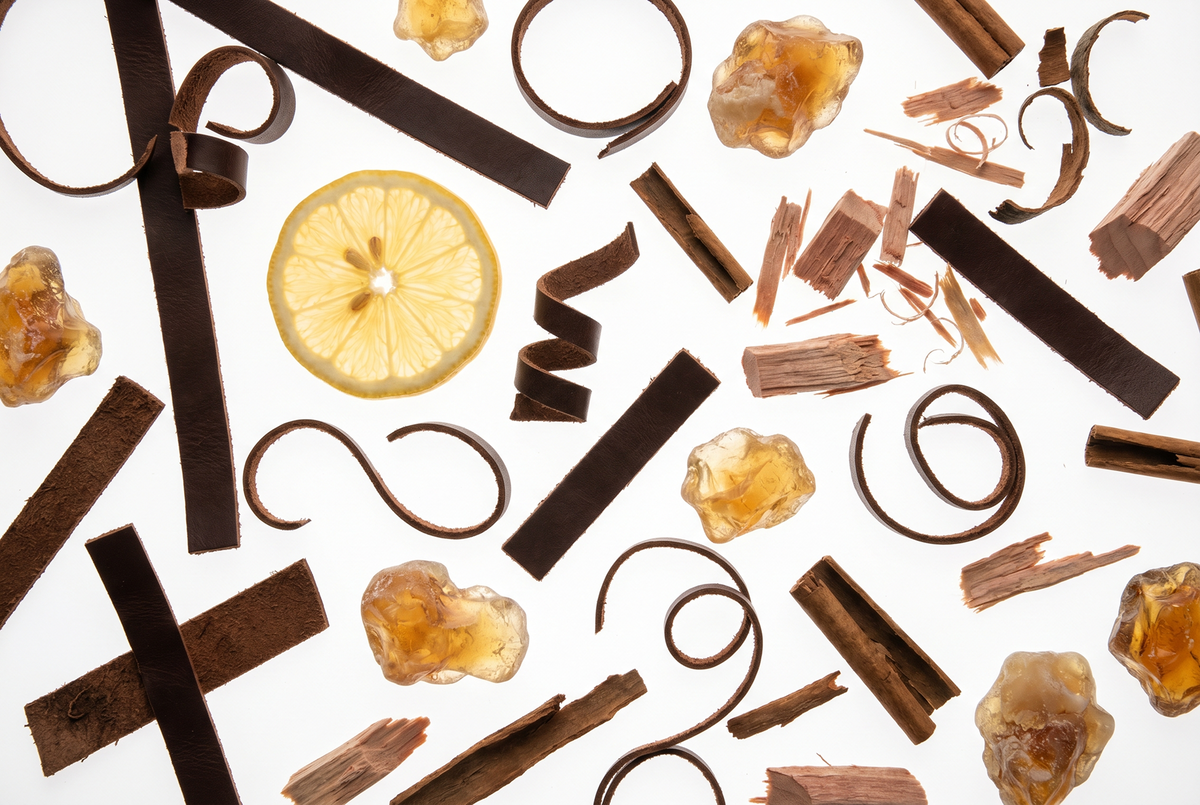 Lemon, wood pieces and amber-colored stones illustrating My Way scent notes
