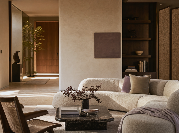 Warm living room with a curved sofa and natural finishes